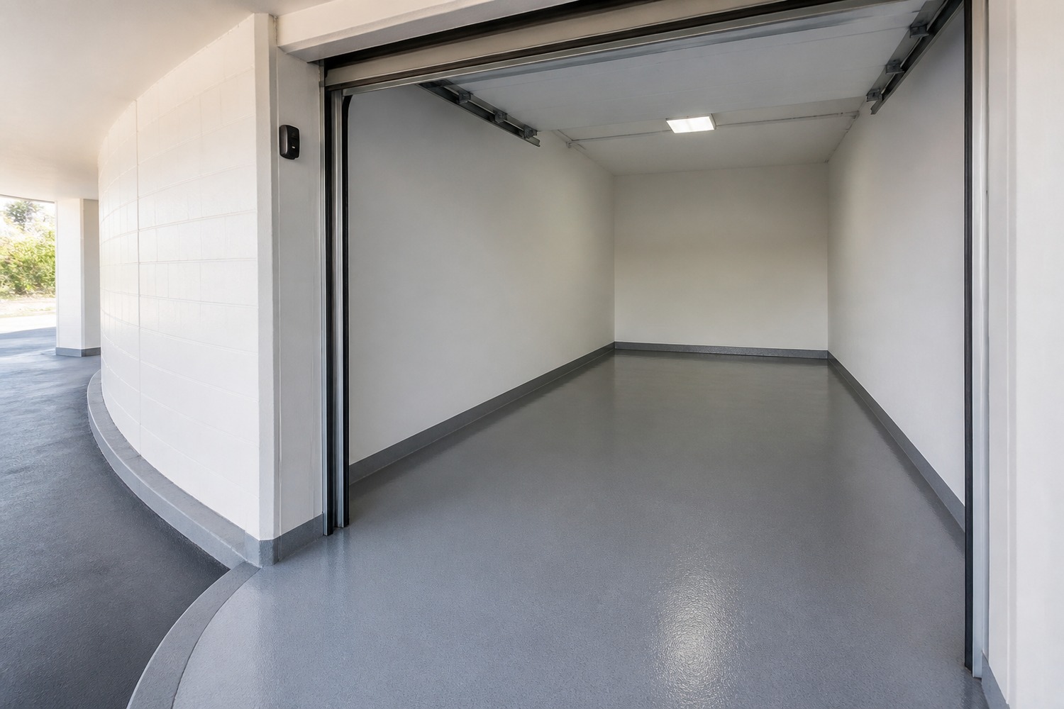 Compact urban garage bay with a coated floor